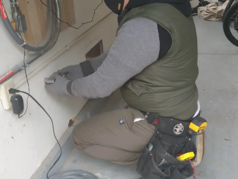 Electrician performing outlet wiring in a Bonne Terre garage